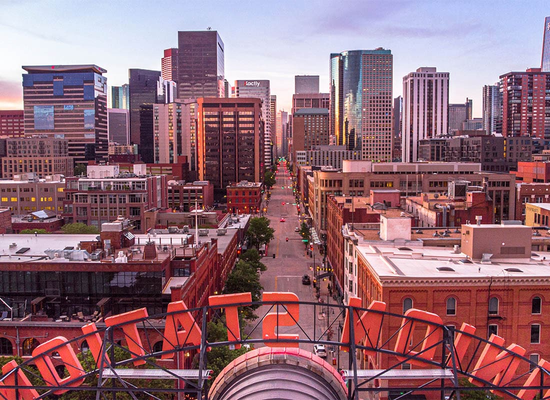 Denver, CO - Stunning City View Looking Down the Main Strip as the Builings Are Tall and the Hue is Red